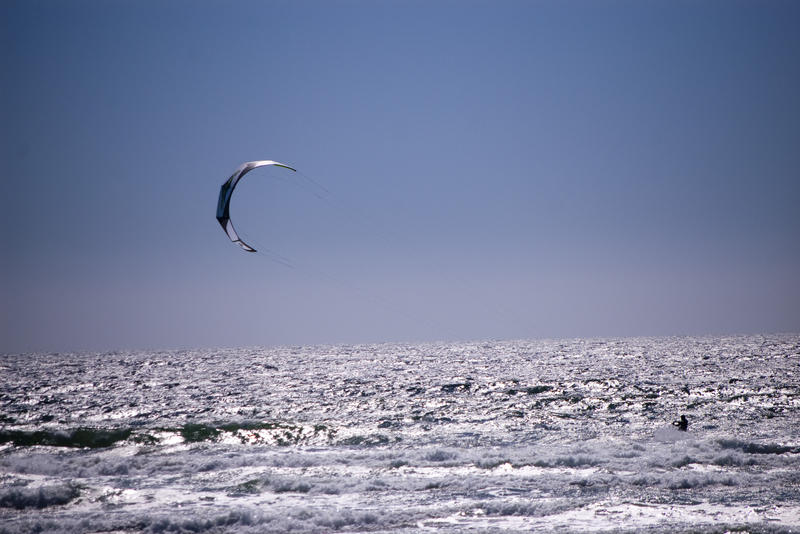 a kitesurfer riding along on the water