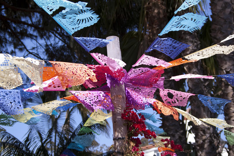 a decorative display of flags that look a little like prayer flags hanging from a temple