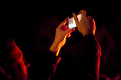 8869   Man taking a photo of a bonfire