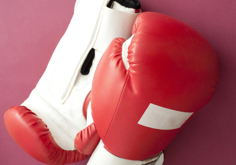 Close up White and Red Boxing Gloves for Fitness Workout on Dark Pink Background