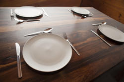 8842   Wooden dining table with four place settings