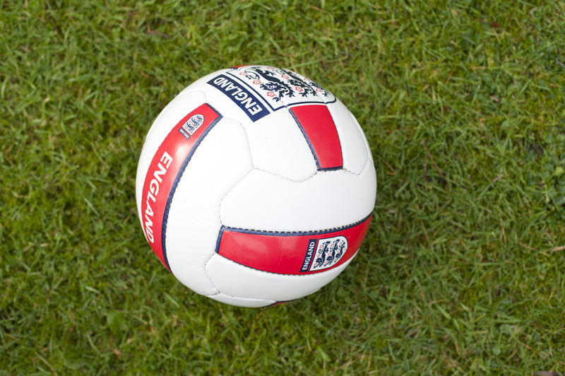 England soccer ball or football on a green field with patriotic England markings supporting the World Cup of competitive sport