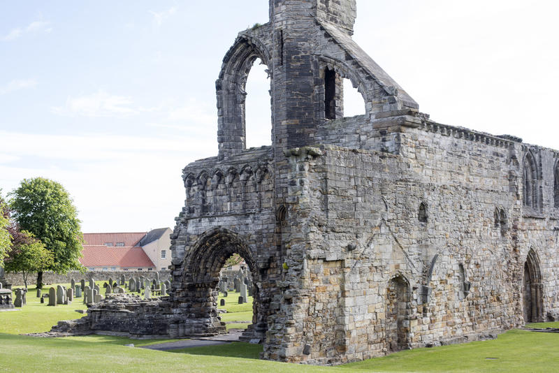 Section of the ruins of St Andrews Cathedral, Scotland showing the remnants of the Gothic arches and ancient stone walls in neatly manicured lawns