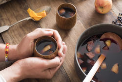 17170   Person warming their hands on mulled wine