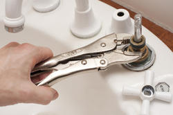 10164   Man repairing a broken faucet or tap