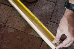 10170   Man measuring a length of wood