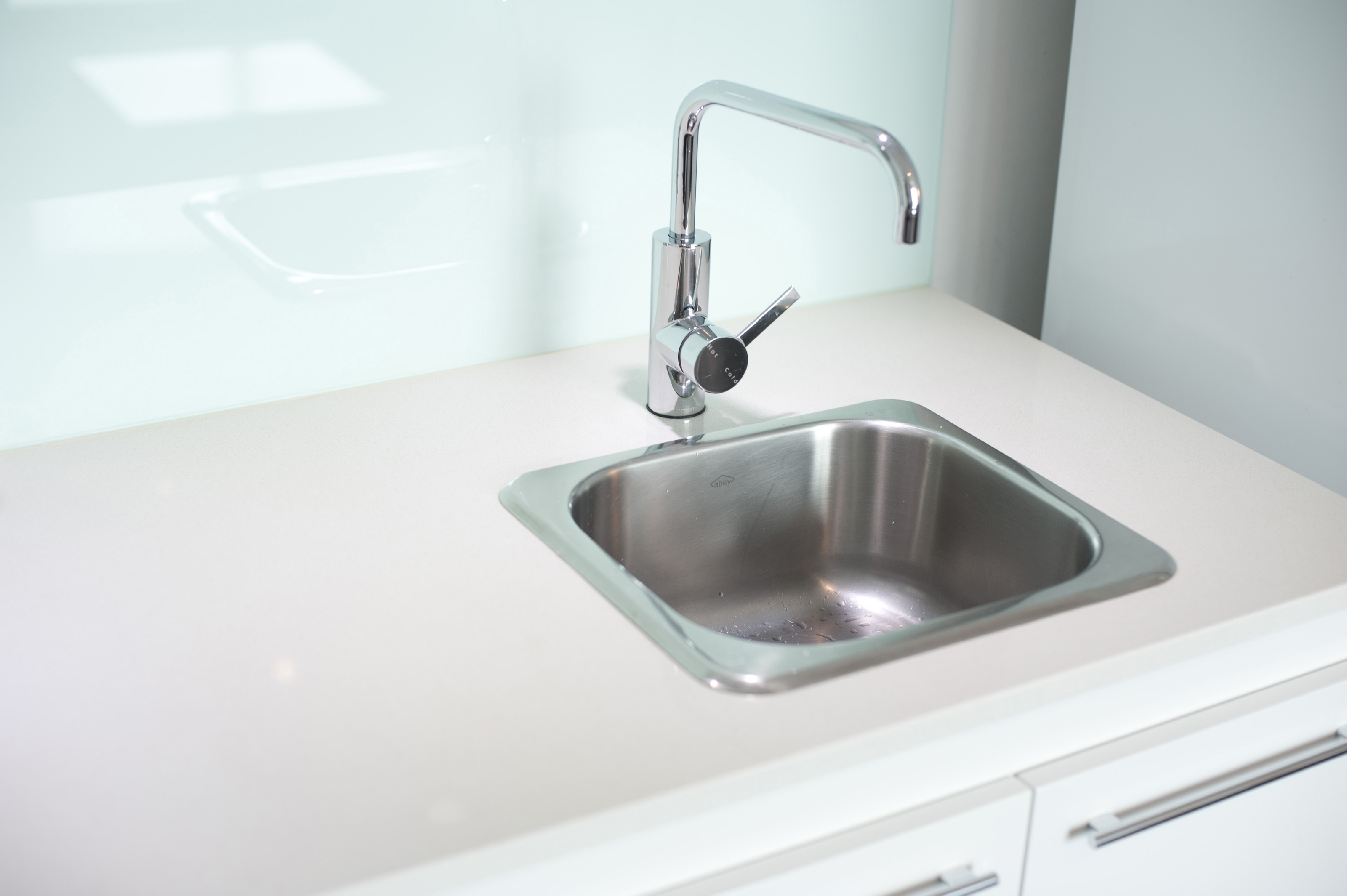 white kitchen sink with stainless steel faucet