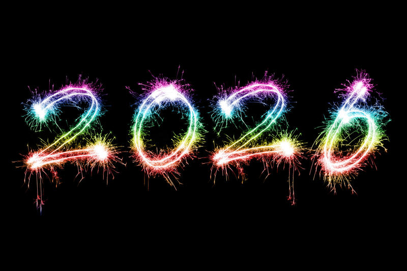 Rainbow coloured sparkling fireworks for the new year holiday 2026 over black backdrop